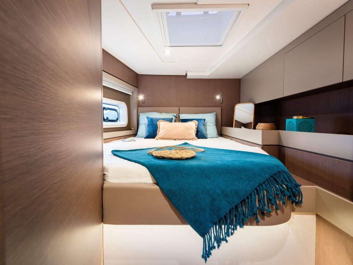 Guest cabin with a double bed and an overhead hatch
