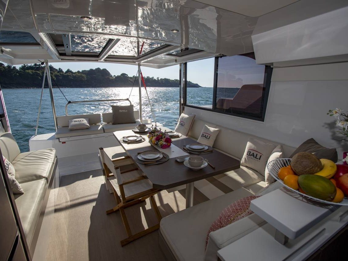 Aft cockpit lounge and dining table opening to the sea