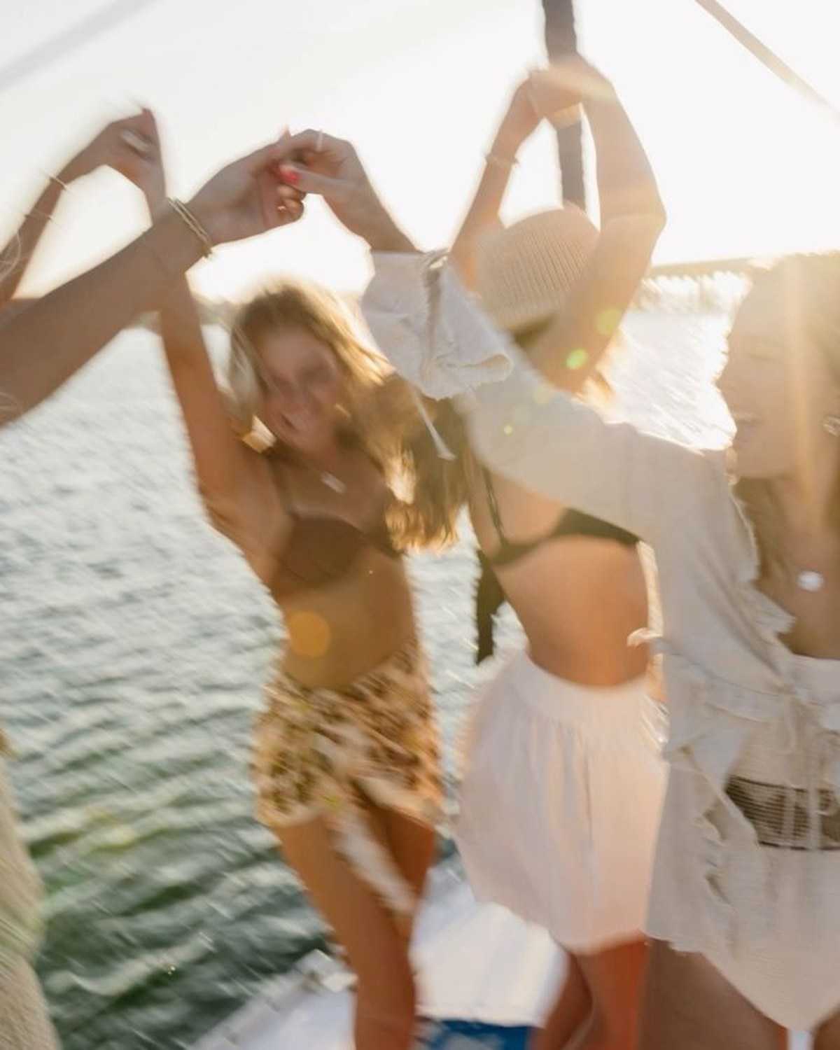 Guests dancing on deck at sunset